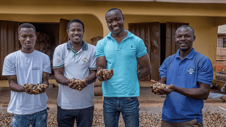 Cashew farmers holding cashews